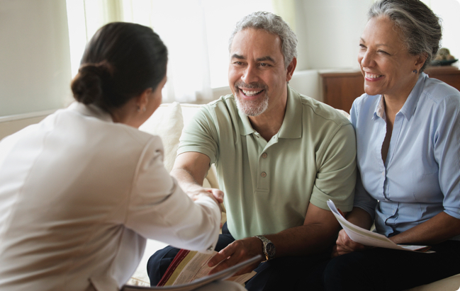 Woman shakes hand with smiling couple